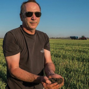 Man holding soil in his hand.