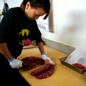 woman cutting meat with a knife