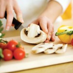 Slicing mushrooms with a knife.