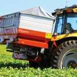 Tractor seeding ryegrass in a field.