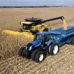 Combine and tractor harvesting in a field.