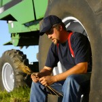 farmer sitting in a field thinking