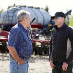 two farmers talking in a field
