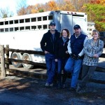 people standing beside livestock trailer