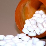 pills spilling out of a medicine bottle