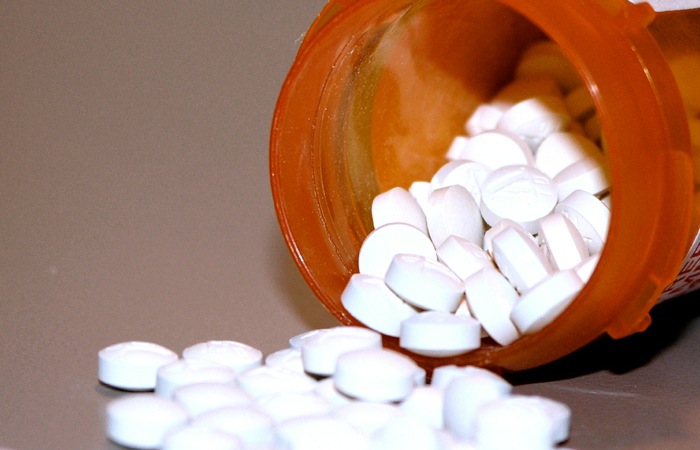 pills spilling out of a medicine bottle