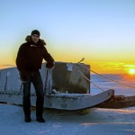 man on arctic ice with sled