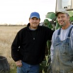 farmers standing beside a tractor