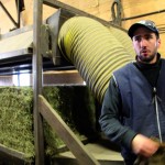 David Normandin of Norfoin Inc., a family-owned haymaking operation in Saint-Césaire, Que., explains the operation, including their homemade wood-fired hay dryer, which can dry 100 large square bales at a time.