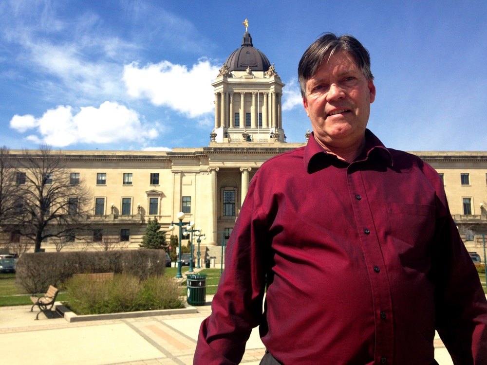 Ian Wishart standing in front of Manitoba Legislature