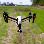 Scott Garvey, machinery editor for Grainews magazine, photographing a UAV (drone) at an in-field demo on the grounds of at Ag in Motion.