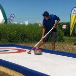 DuPont Pioneer’s booth includes an outdoor “rink” and the chance to throw a rock with two-time Brier champion Pat Simmons.