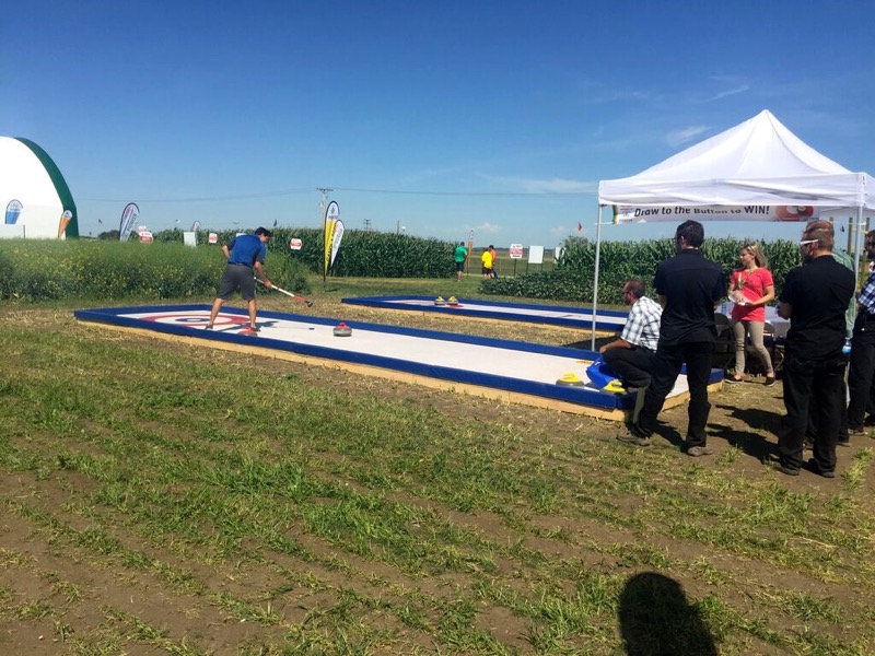 DuPont Pioneer’s booth includes an outdoor “rink” and the chance to throw a rock with two-time Brier champion Pat Simmons.