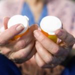 Woman holding pill bottles