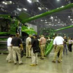 Dealers look over new combines during a product launch in the U.S. Will Trump’s trade policies force them to charge farmers even more for new equipment?