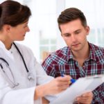 doctor talking to her male patient at office