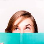 An isolated shot of a beautiful woman reading a book
