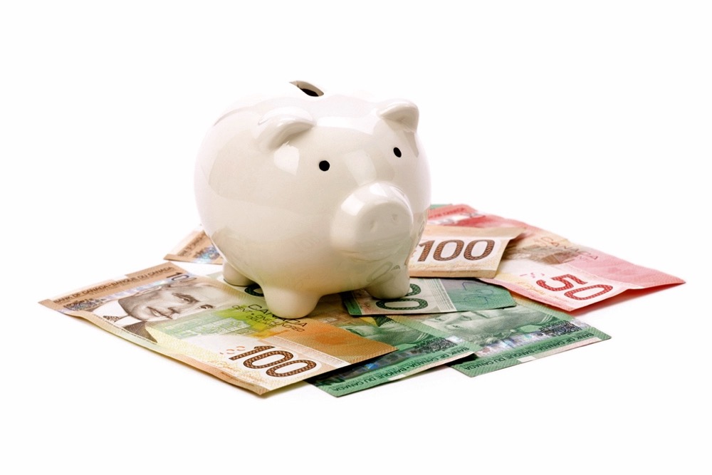Piggy Bank and canadian dollars close up shot