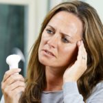 Mature Woman Experiencing Hot Flush From Menopause