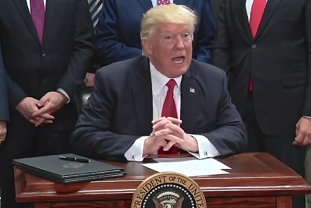 U.S. President Donald Trump signs an executive order April 29 in Pennsylvania on the establishment of the Office of Trade and Manufacturing Policy. (Screengrab from video at Whitehouse.gov)

