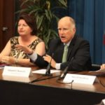 California Governor Jerry Brown (shown here Tuesday, third from right, with state lawmakers) has signed legislation to put a water bond to voters in November. (Justin Short photo, Gov.Ca.gov)
