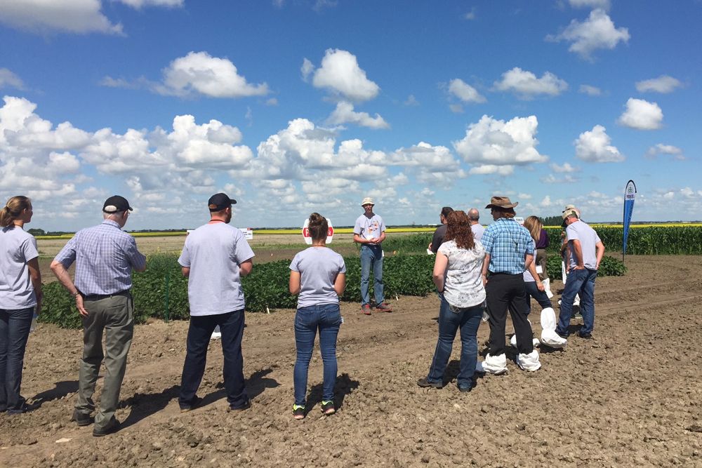Julian Heath, research operations lead at the newly expanded Saskatoon facility, explains the Saskatoon plots to open-house guests. (Leeann Minogue photo)
