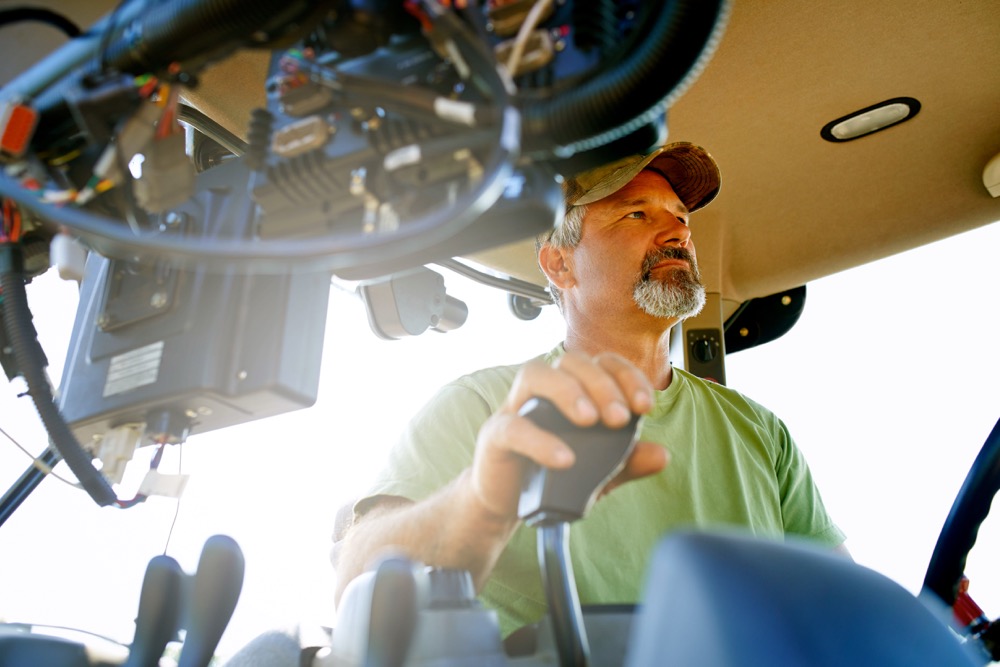 man working inside a tractor