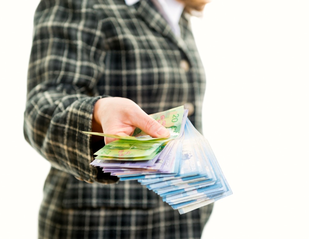 Woman holding lots of money bills