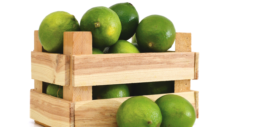 A green lemons on wooden box