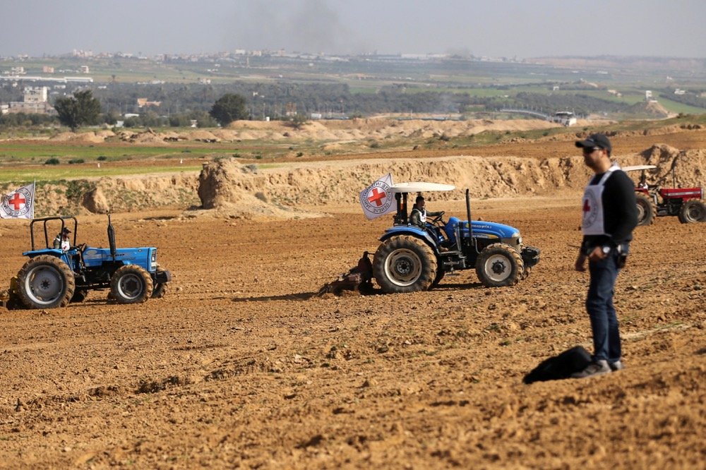 Palestinian farmers, helped by the International Committee of the Red Cross (ICRC), use tractors to plow a field near the Israel Gaza border in the central Gaza Strip on Feb. 3, 2020. (Photo: Reuters/Ibraheem Abu Mustafa)
