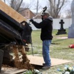 Cemetery employees fill in the grave of JBS USA meat packing plant employee Saul Sanchez on April 15, 2020 at Greeley, Colorado, following his death from COVID-19. (Photo: Reuters/Jim Urquhart)