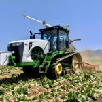 A John Deere tractor retrofitted with a Bear Flag Robotics autonomous system works a field in California.