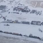 A supplied aerial photo of vehicles blocking through traffic on Feb. 1, 2022 at the Canada-U.S. border crossing between Coutts, Alta. and Sweet Grass, Montana. (Photo courtesy Alberta RCMP)