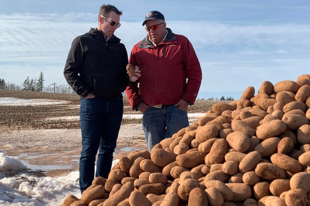 Federal Conservative ag critic and Alberta MP John Barlow speaks with P.E.I. potato grower Alex Docherty (r) in a March 18, 2022 photo. (John Barlow photo via Facebook)
