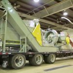 A mobile biomass densification system, developed at PAMI in Portage la Prairie and shown here in a 2012 video, was used to process biomass such as straw into solid blocks, for ease of transport or for use in biomass burners. (BioScience Association Manitoba video screengrab via YouTube)