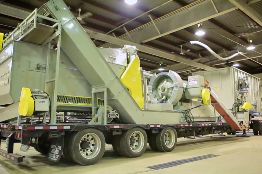 A mobile biomass densification system, developed at PAMI in Portage la Prairie and shown here in a 2012 video, was used to process biomass such as straw into solid blocks, for ease of transport or for use in biomass burners. (BioScience Association Manitoba video screengrab via YouTube)
