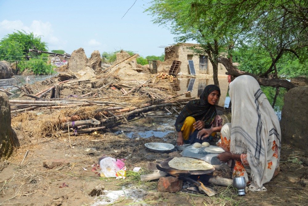 People cook food beside their damaged house following rains and floods during Pakistan’s monsoon season at Jafarabad, about 400 km north of Hyderabad, on Aug. 28, 2022. (Photo: Reuters/Amer Hussain)
