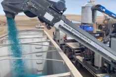 A G-Mac&#8217;s custom seed treatment unit loads a truck with treated peas in a 2020 video screengrab. (G-Mac&#8217;s AgTeam via YouTube)
