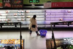 A customer looks at food items displayed on shelves at a supermarket, amid the COVID-19 outbreak in Shanghai, China on Nov. 30, 2022. (Photo: Reuters/Aly Song)