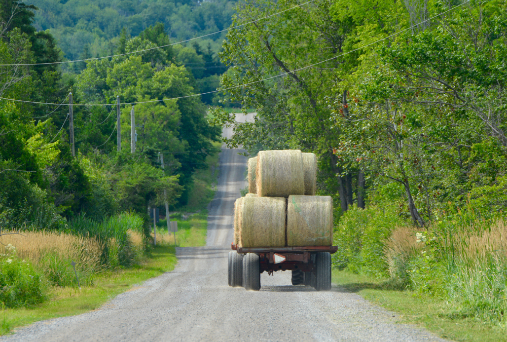 wagon with hay bales pulled by tractor