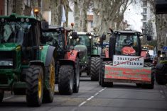 Farmers protesting in Toulouse, France, on January 16, 2024, with tractors bearing placards that read ‘Macron still an effort, soon all farmers will be dead’. Photo by Alain Pitton/NurPhoto via Reuters