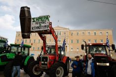 Greek farmers, with their tractors, protest in front of the Greek parliament over rising energy costs and competition from imports in Athens, Greece, February 20, 2024. REUTERS/Louisa Gouliamaki