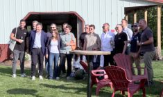 A group of attendees at the networking event pose for a ‘family photo’ outside the Business Lounge at Canada’s Outdoor Farm Show. Photo: Greg Berg