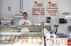 man holding an ice cream cone in an ice cream shop