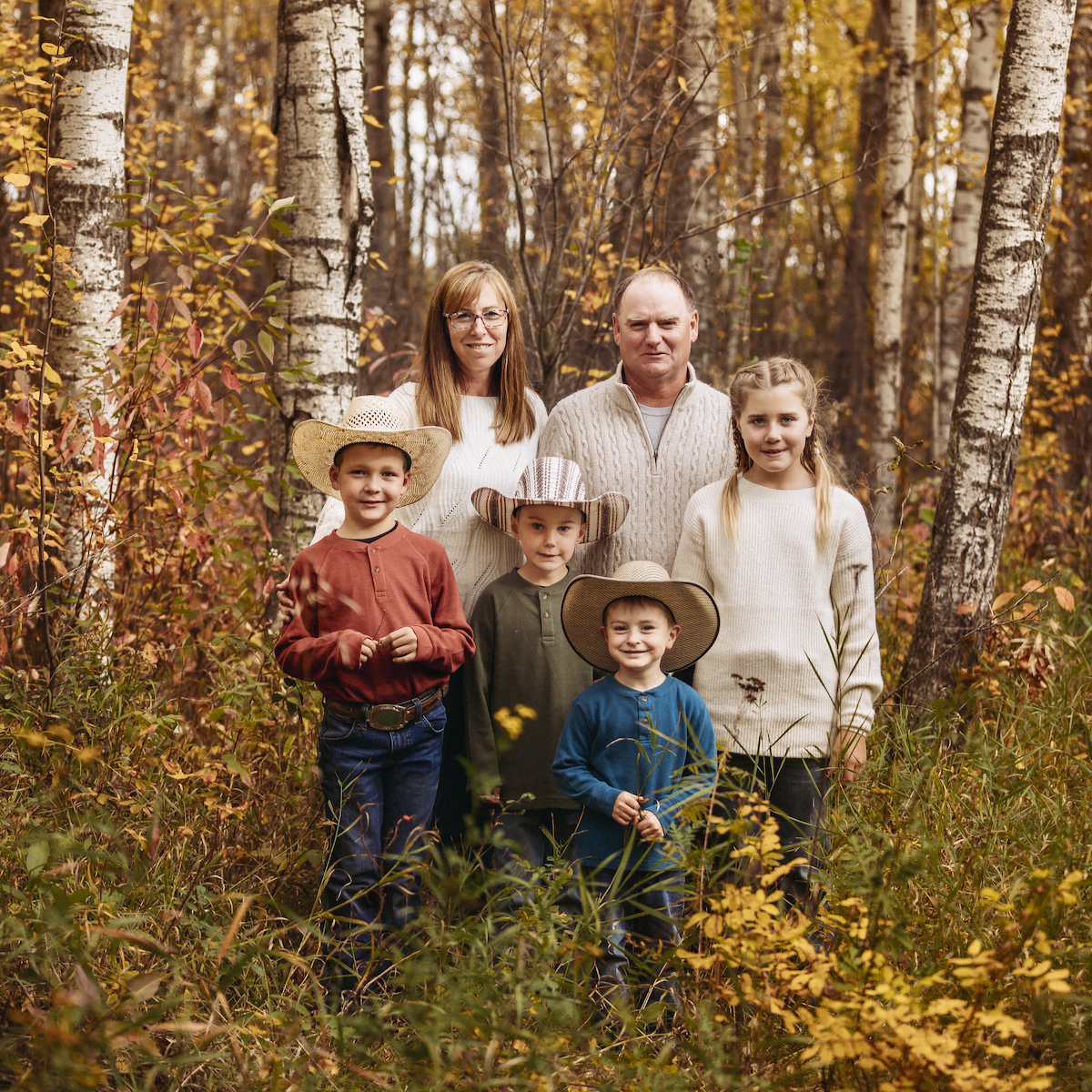 autumn family portrait in a forest with trees