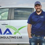 Mike Palmier standing beside a white truck