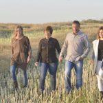 Alanna Koch and family in a field of canola stubble