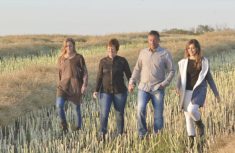 Alanna Koch and family in a field of canola stubble