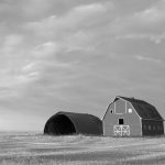 barns and grain bins on prairie farm land