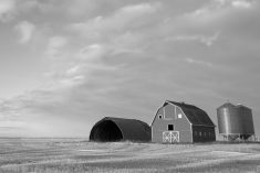 barns and grain bins on prairie farm land